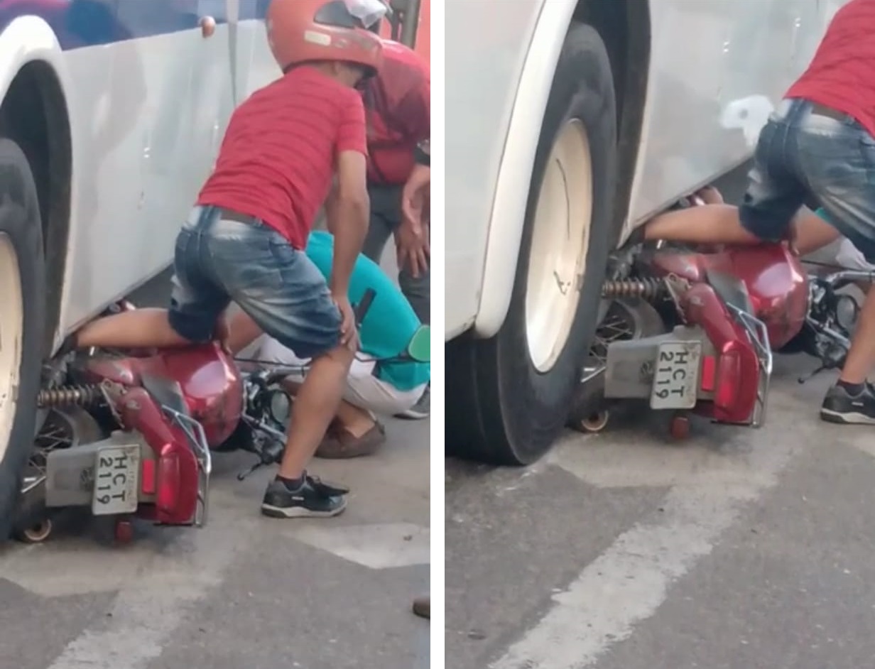 Motociclista inabilitado é conduzido à delegacia após ficar com a perna presa sob ônibus em rotatória